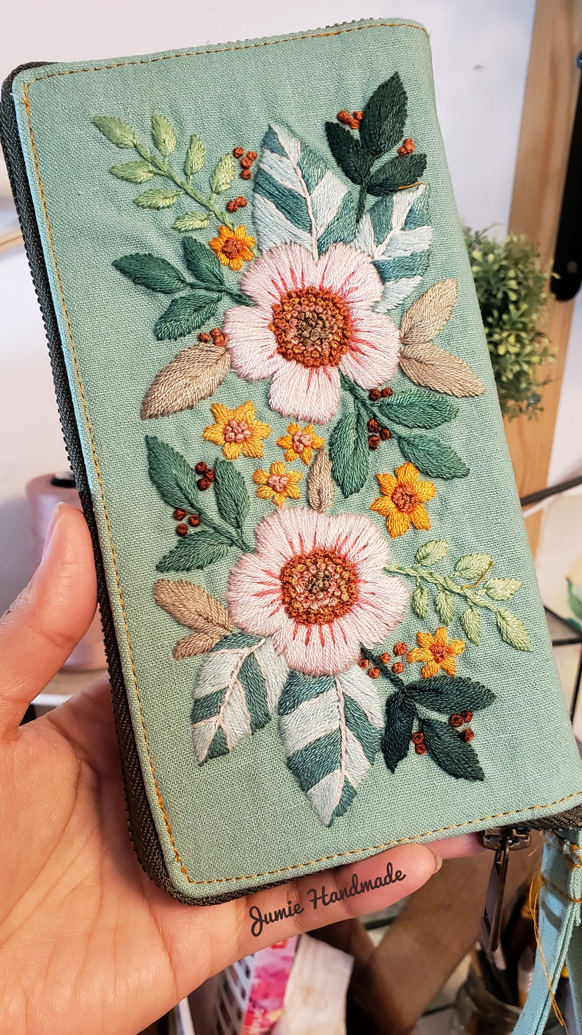 Hand embroidered purse in mint with floral design