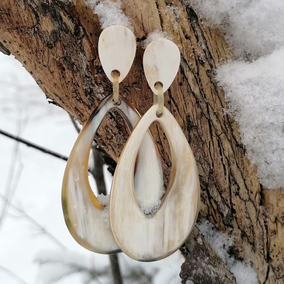 horn earrings in a snowy forest